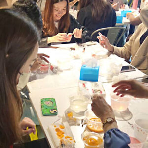 Image of the PwC participants happily enjoying the jelly cake making process