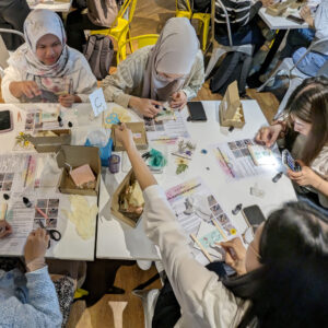 Image of participants creating their resin accessories at the workshop held at PwC