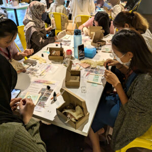 Image of participants creating their resin accessories at the workshop held at PwC